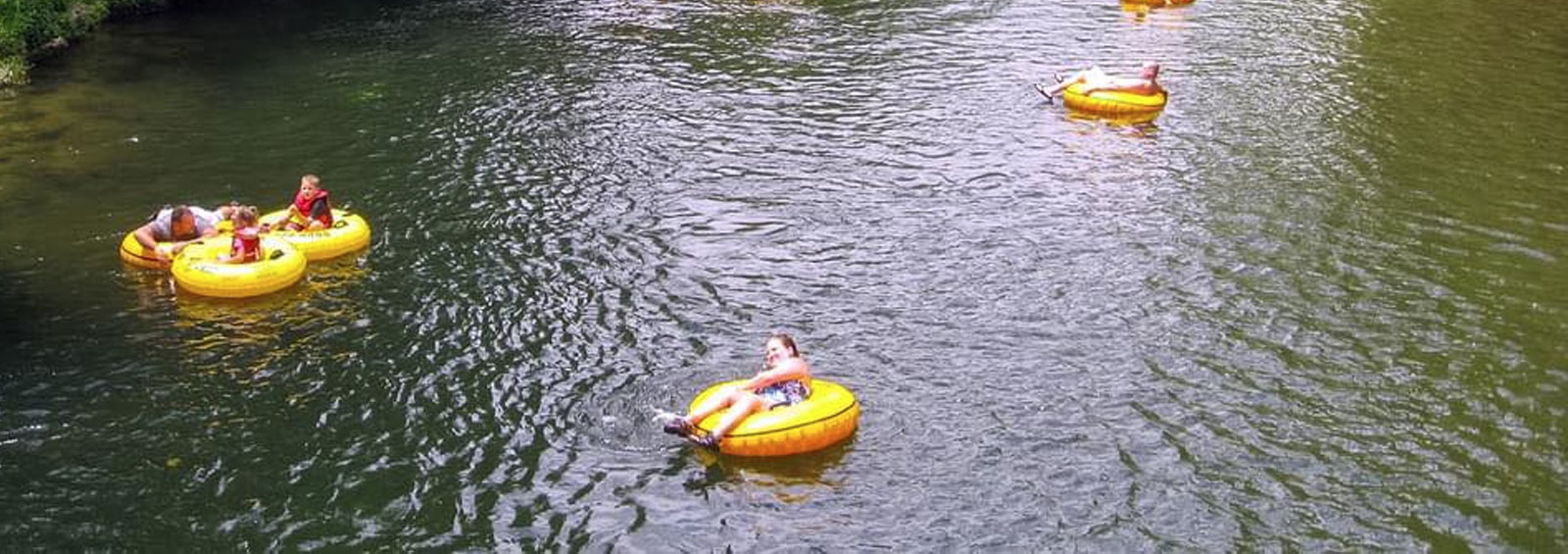 People Floating Along River